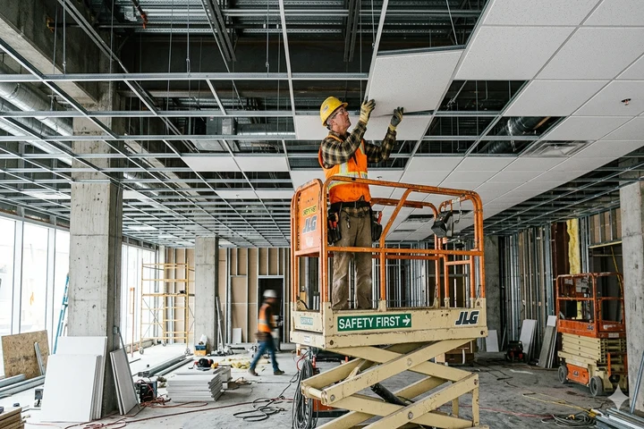 T-bar suspended ceiling grid installation in a Calgary commercial building by Alpine Drywall
